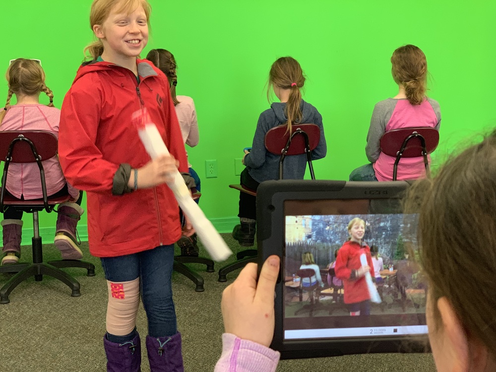 students with green screen in studio 